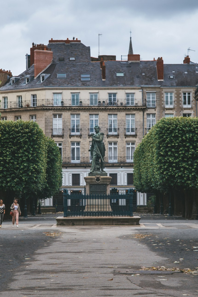 green trees in front of brown concrete building
